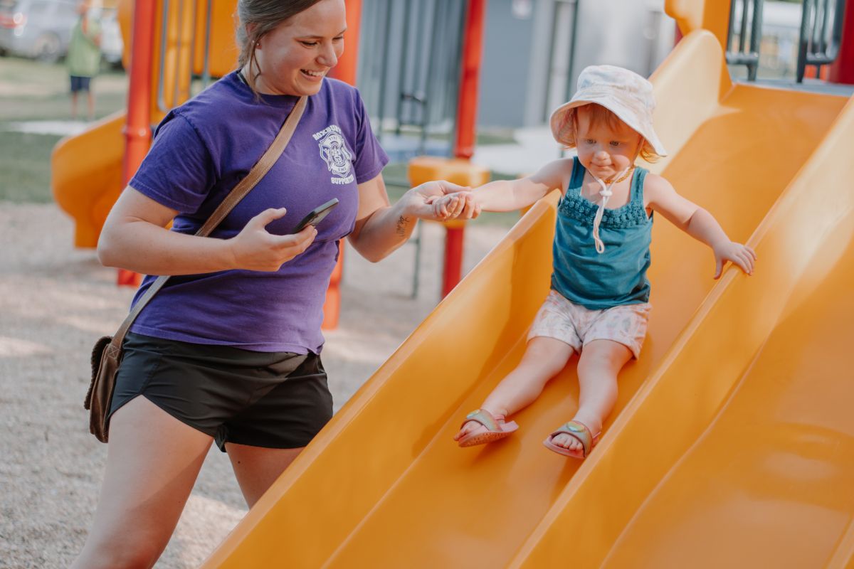 child sliding down slide